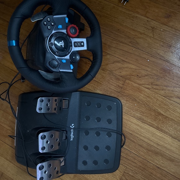 Logitech steering wheel and pedals. Comes with Mystery PS4 game.